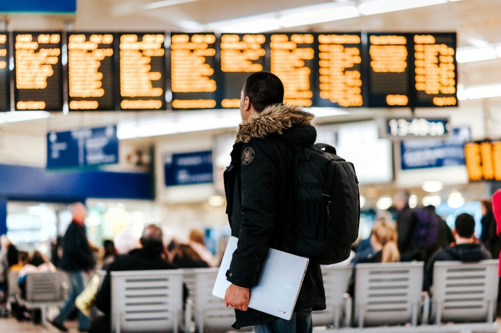 Traveller checking airport departure board for dummy return flight ticket booking
